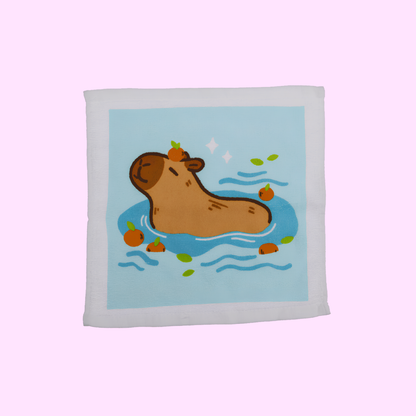 Capybara - Magisches Baumwollhandtuch 30x30cm - Capybara mit blauem Hintergrund - SNACKS24.AT