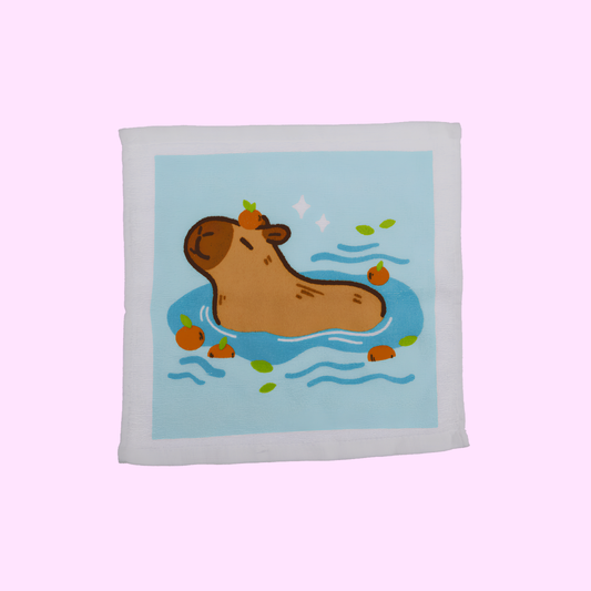 Capybara - Magisches Baumwollhandtuch 30x30cm - Capybara mit blauem Hintergrund - SNACKS24.AT